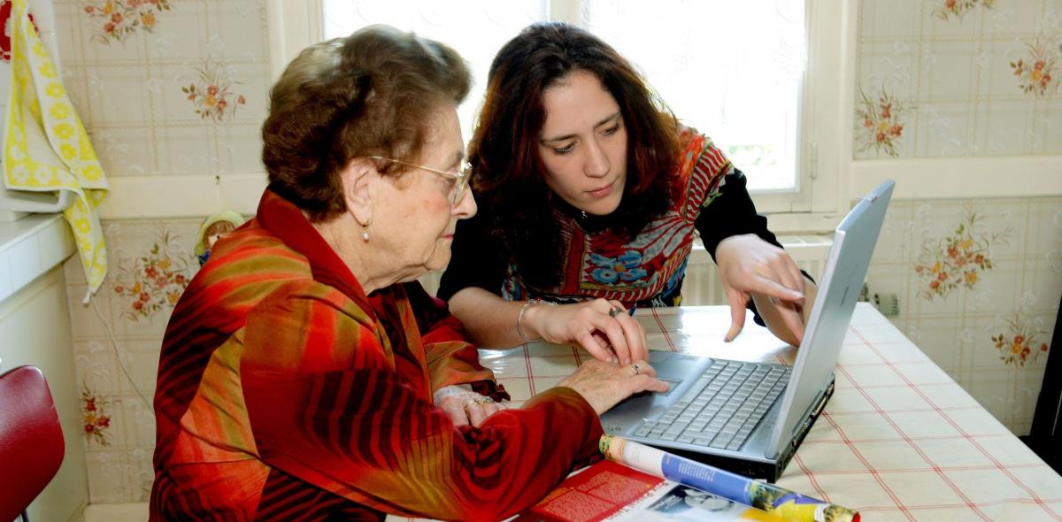Oudere en jongere vrouw achter laptop